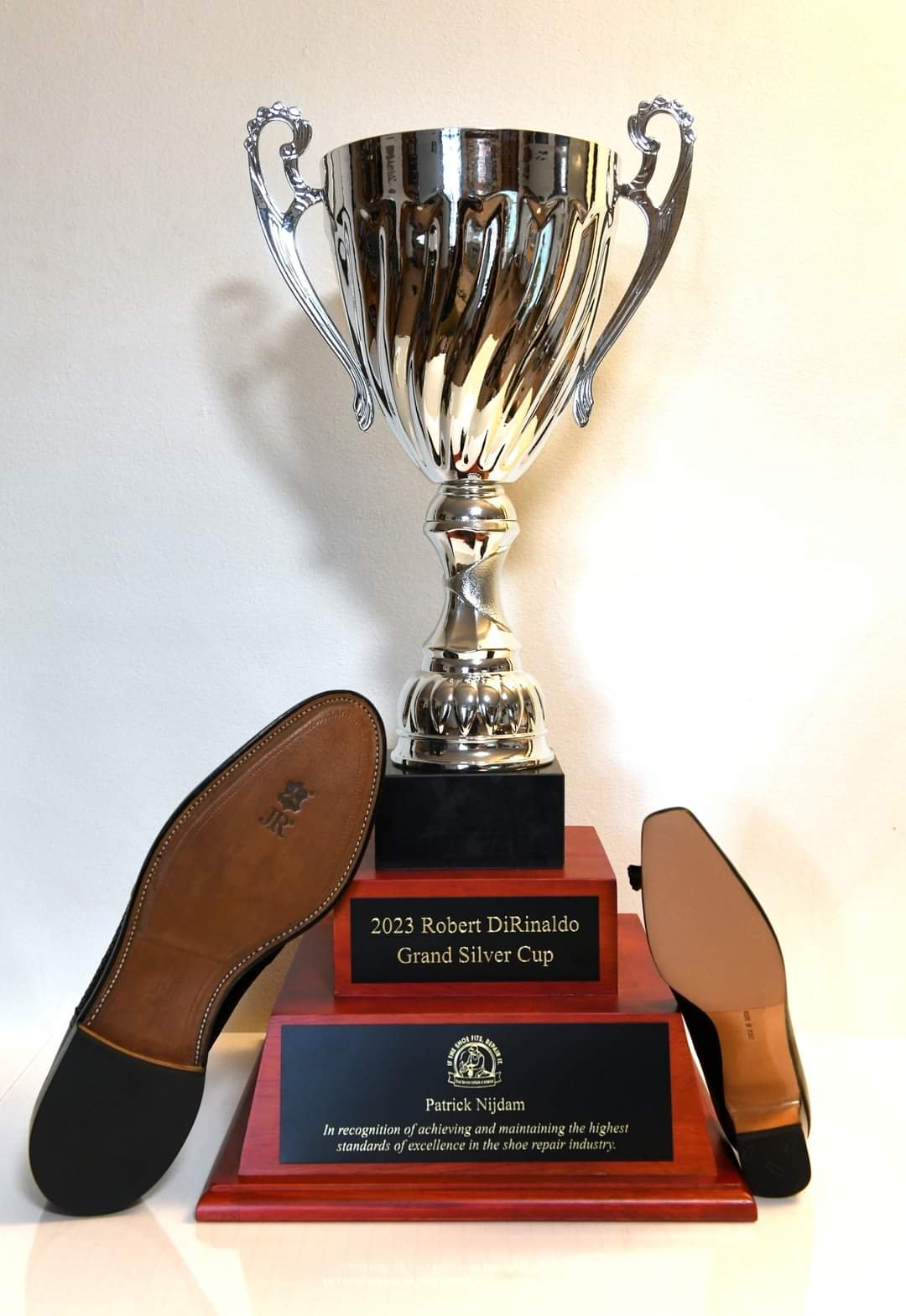 Patrick Nijdam’s 2023 Robert DiRinaldo Grand Silver Cup, with award plaque and two shoe soles.