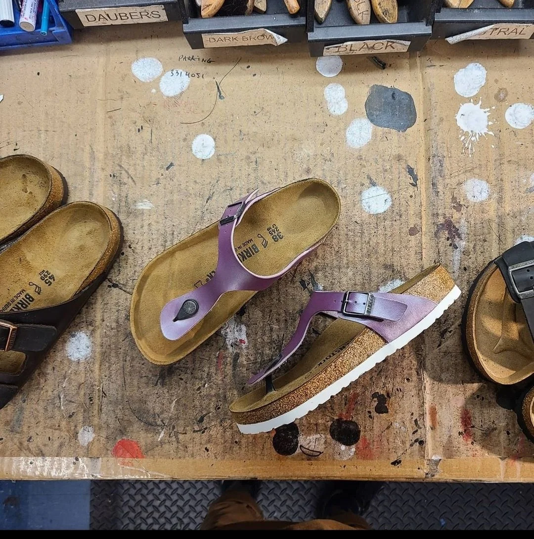 Birkenstock sandals being rebuilt at the workbench